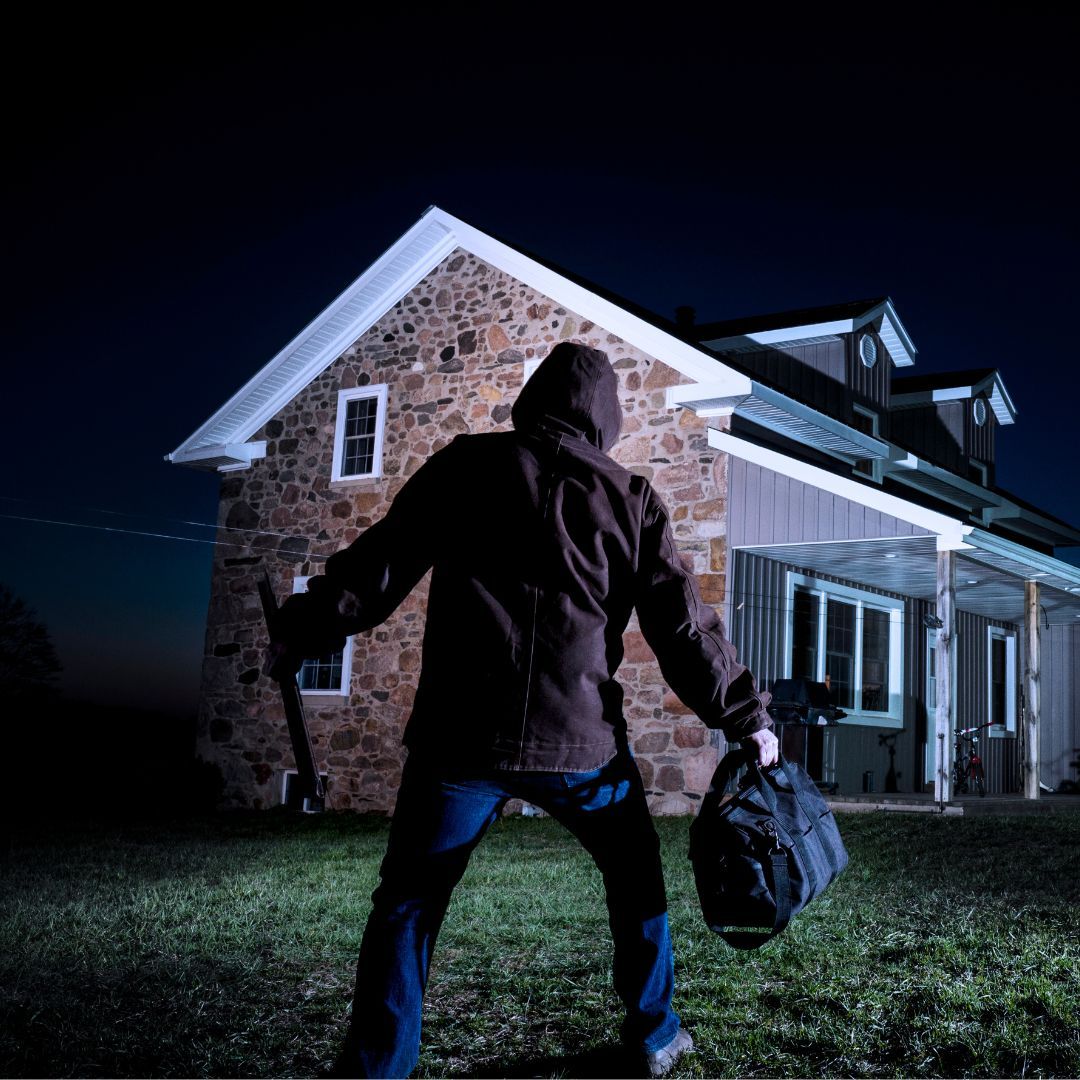 Burglar approaches house to test garage door security